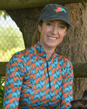 Person in colorful jacket with a dog in a forest setting
